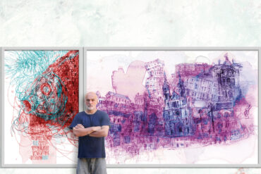 Vladimir Radibratovic poses in front of a piece of art from his "Cityscapes" series.
